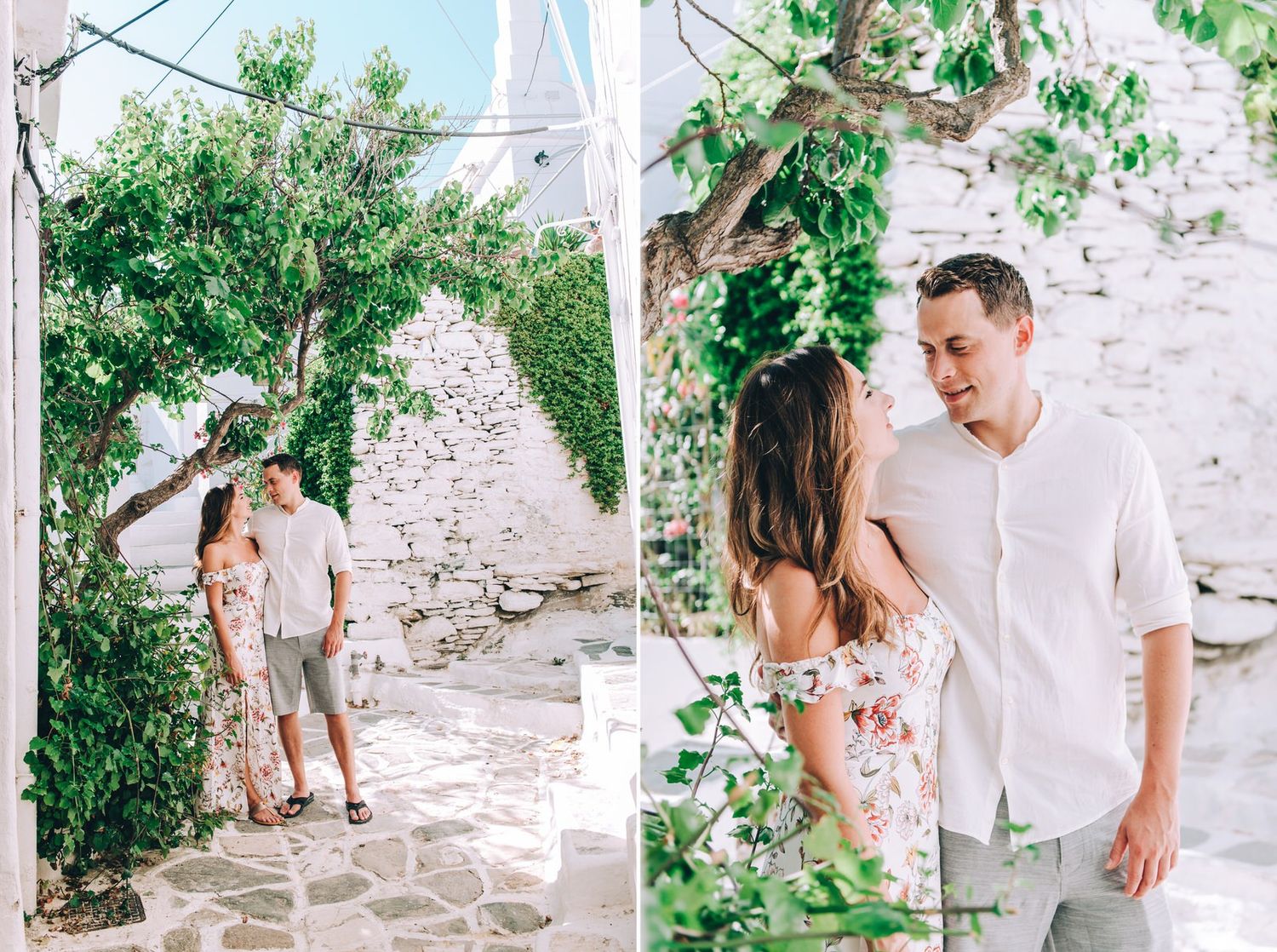 A romantic moment captured among lush greenery and white stone walls in a Mediterranean setting.