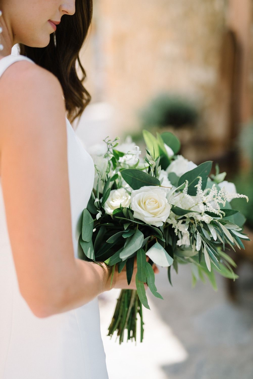 bride portrait holding the wedding flowers at agreco farms in crete greece