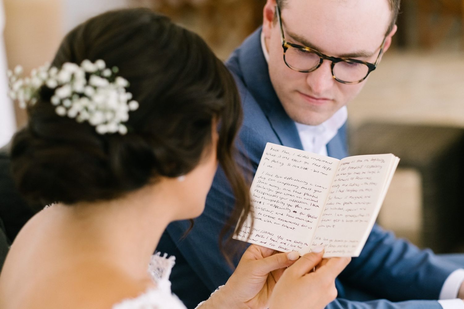 bride and groom reading their vows