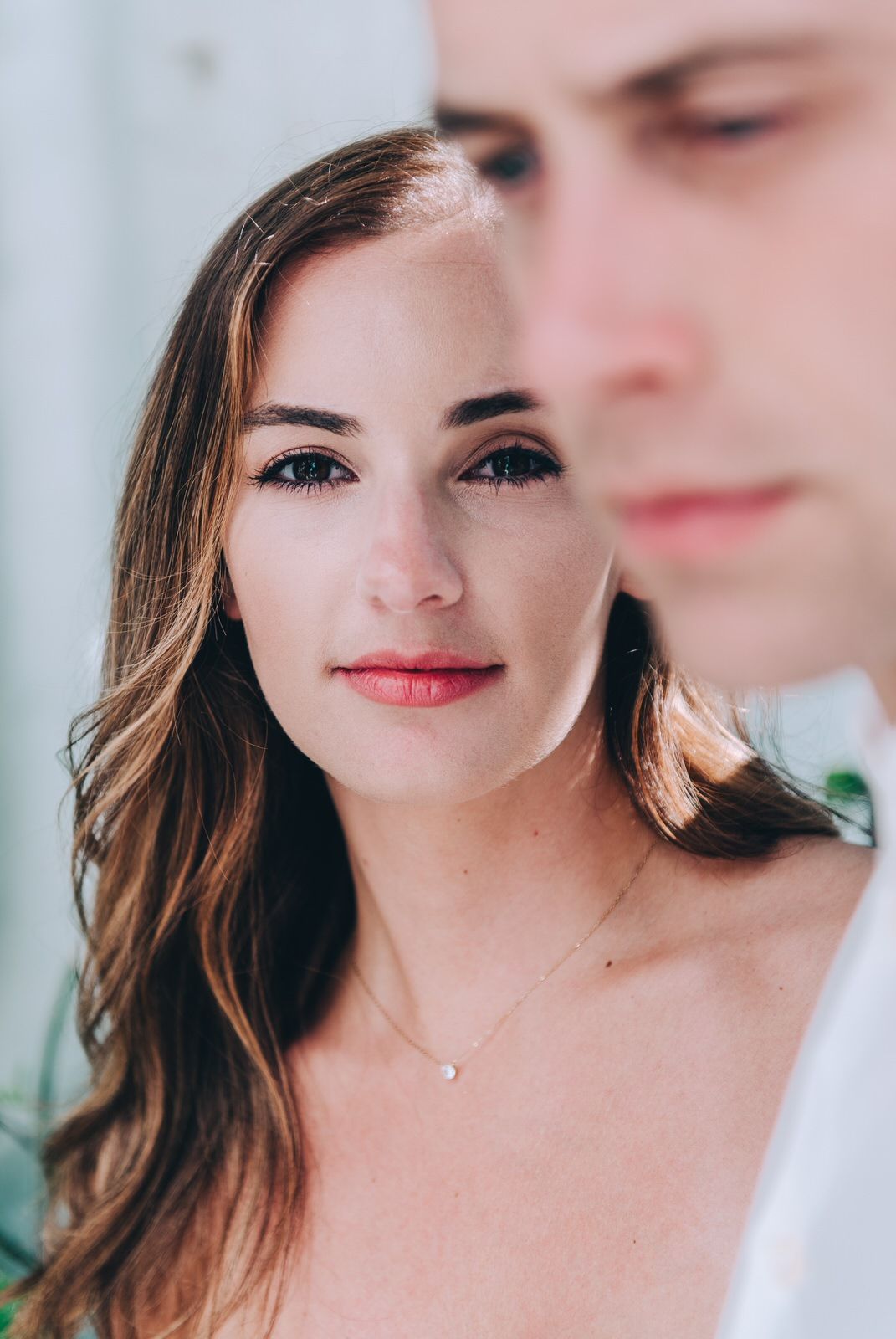 An intimate portrait against a soft white background capturing tender emotions.