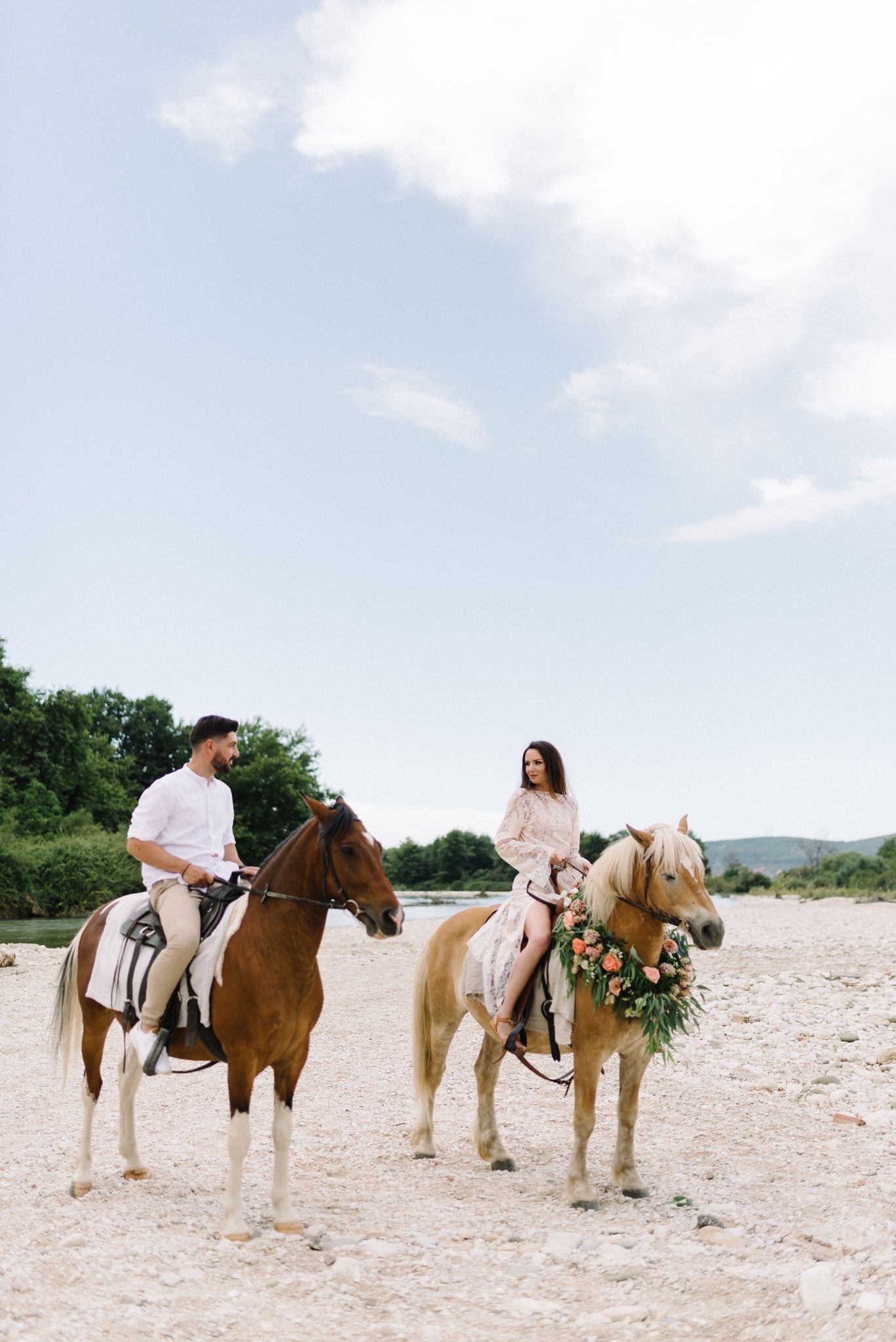 couple riding horses in acheron river in greece
