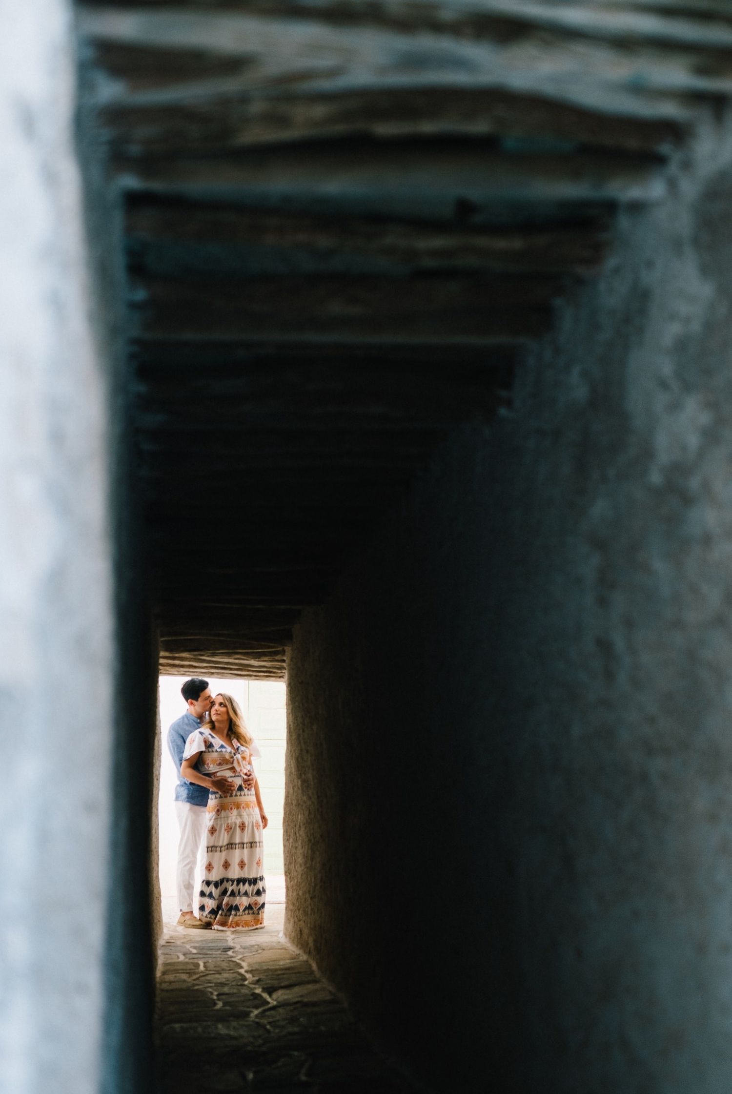 A stone tunnel with natural light streaming in from the end opening.