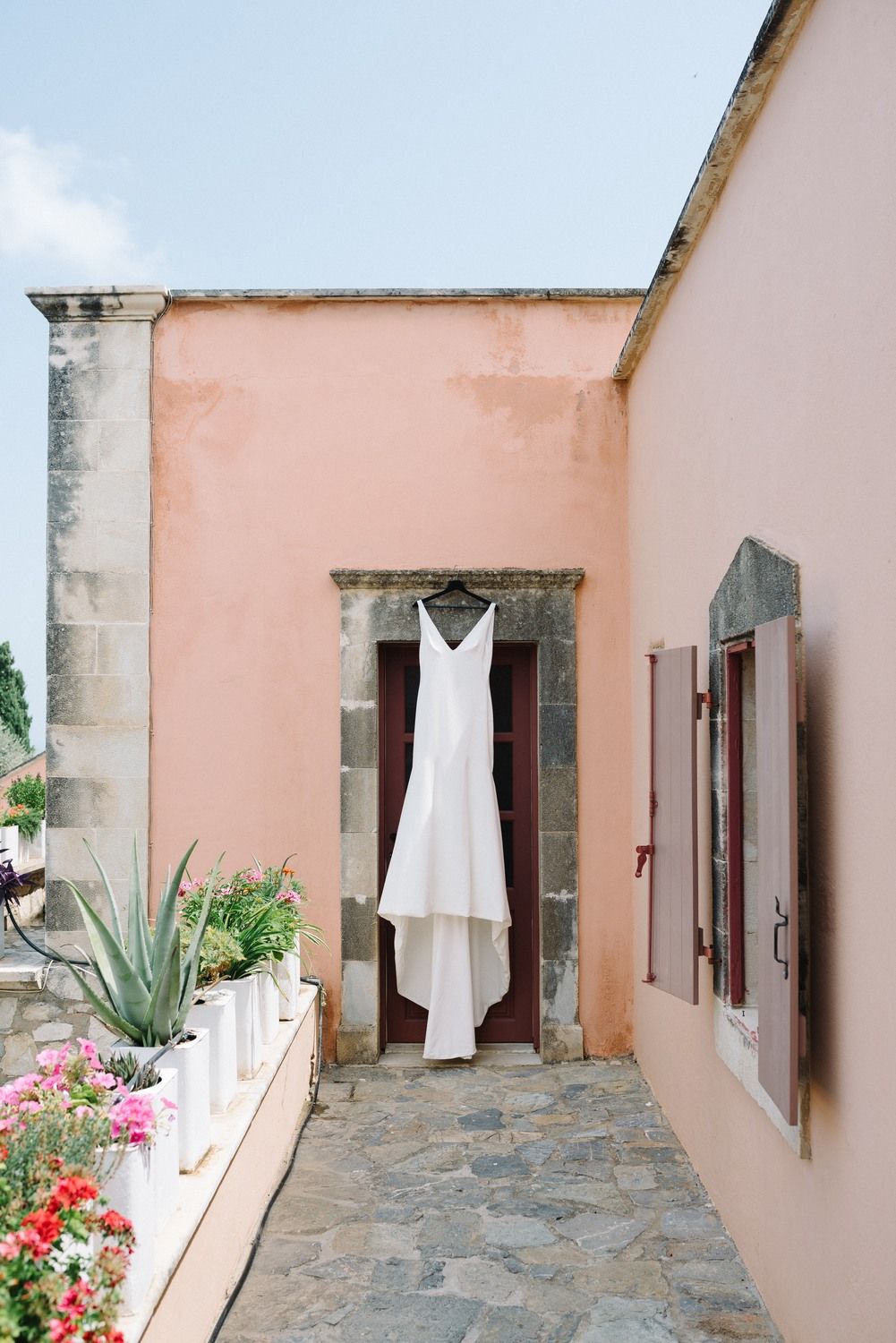 wedding dress in front of an old door at agreco farms in crete