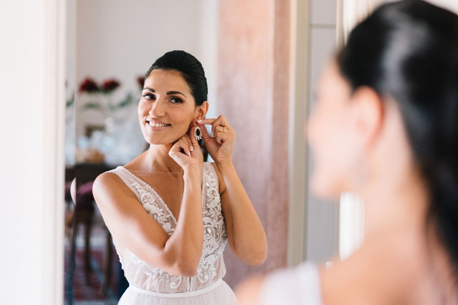 bride wearing her earrings