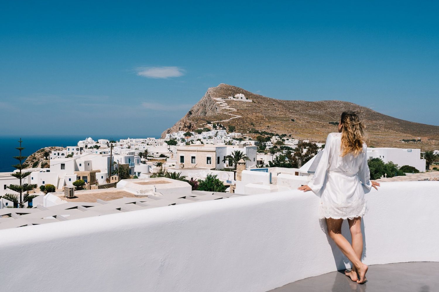 brides portrait with amazing view in her balcony from Folegandros island