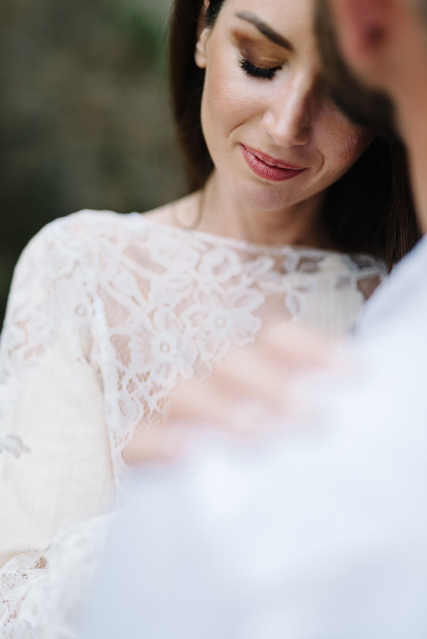 Soft focus portrait showing delicate lace details and subtle makeup.