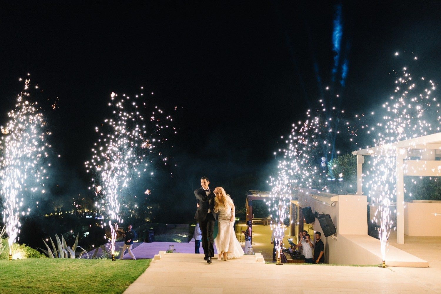 couple is entering with fireworks the wedding reception in athens riviera