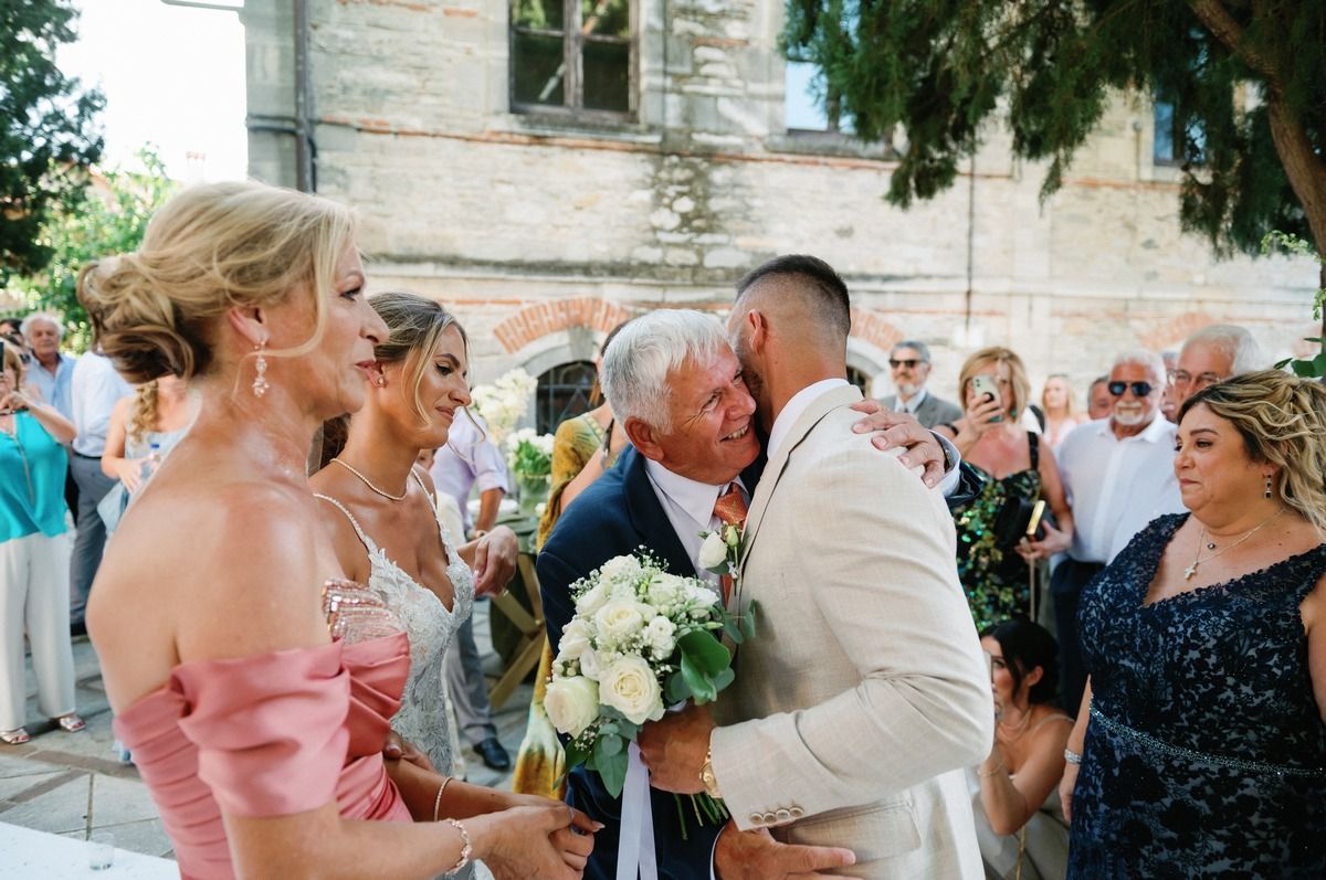 Wedding celebration with guests gathered around during outdoor reception.