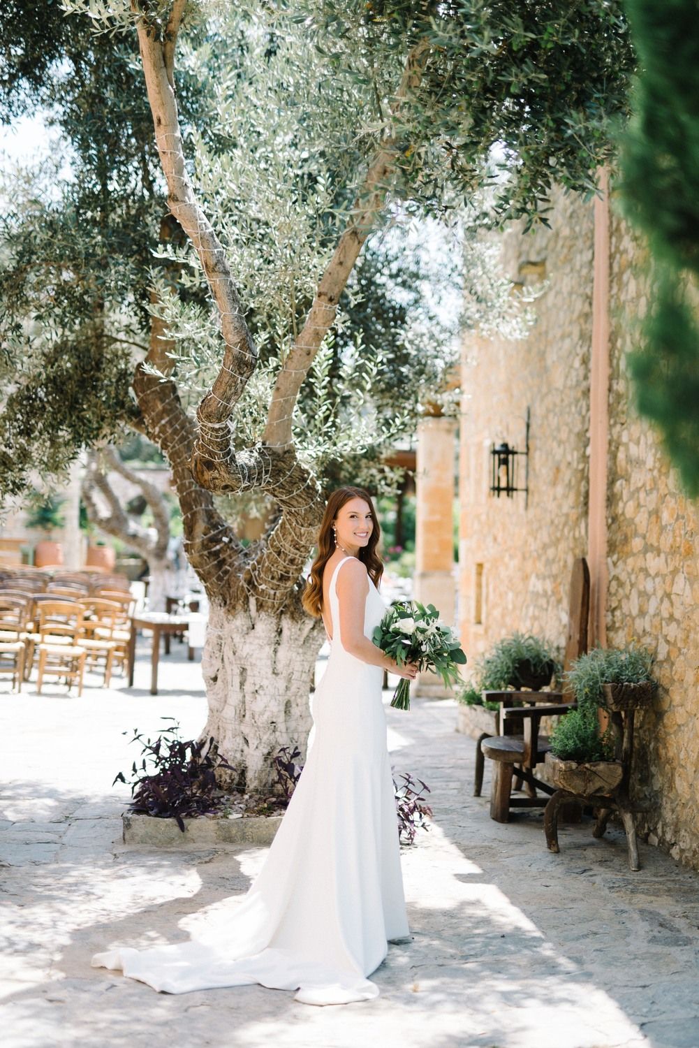 bride portrait holding the wedding flowers at agreco farms in crete greece