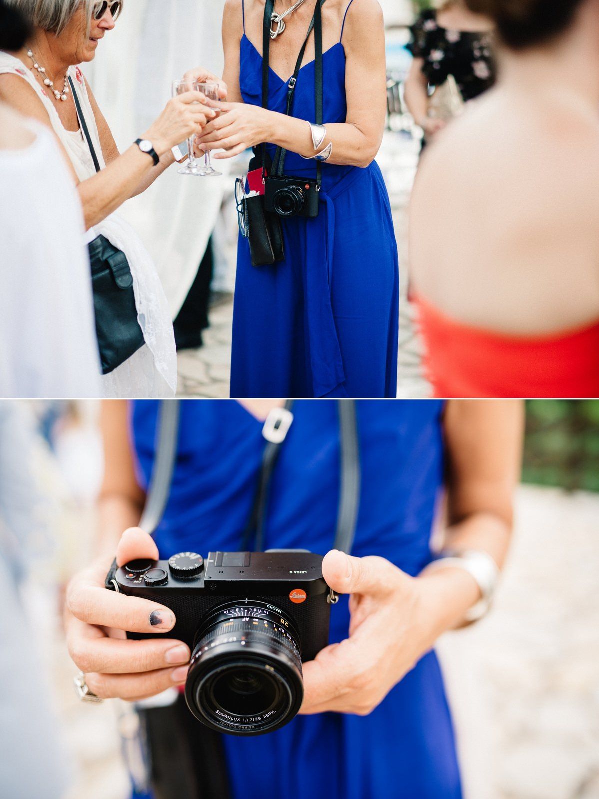 Guest in blue dress holding professional camera at outdoor wedding reception.