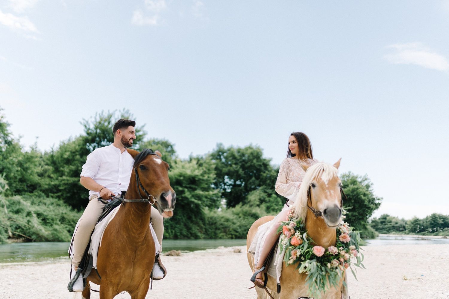 couple riding horses in acheron river in greece