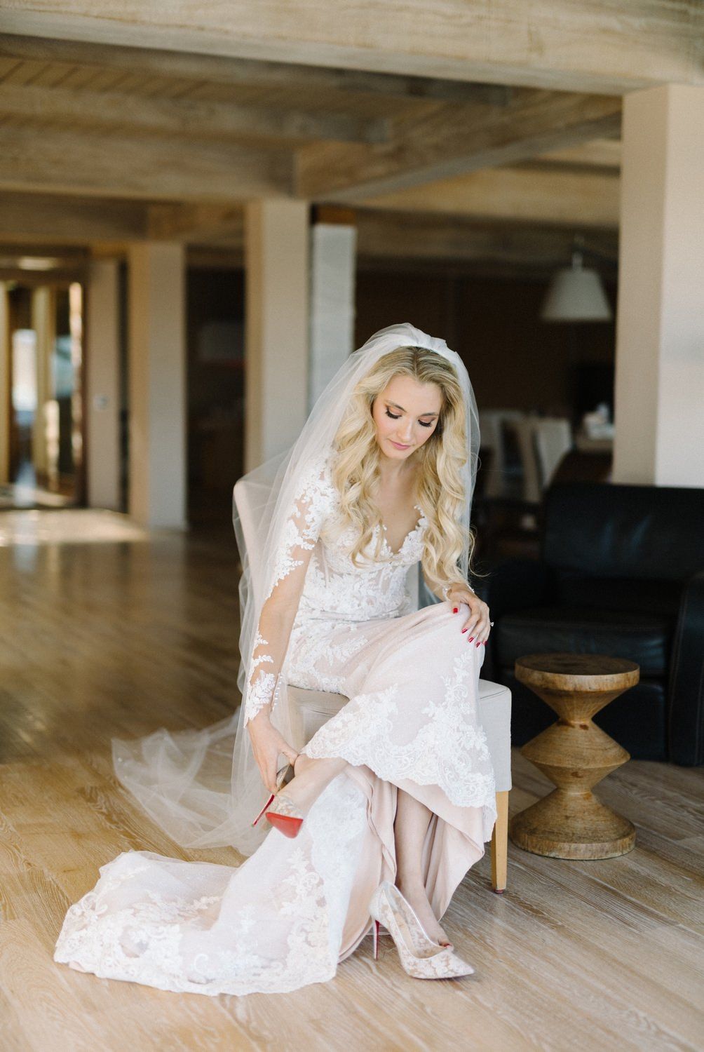 bride is wearing her christian louboutin shoe