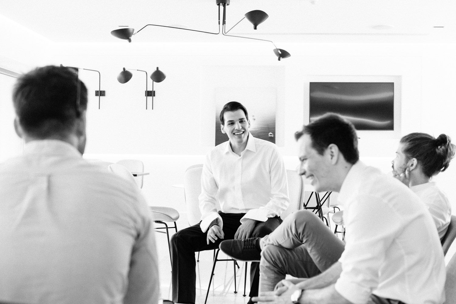Business meeting in progress with professionals seated in discussion.