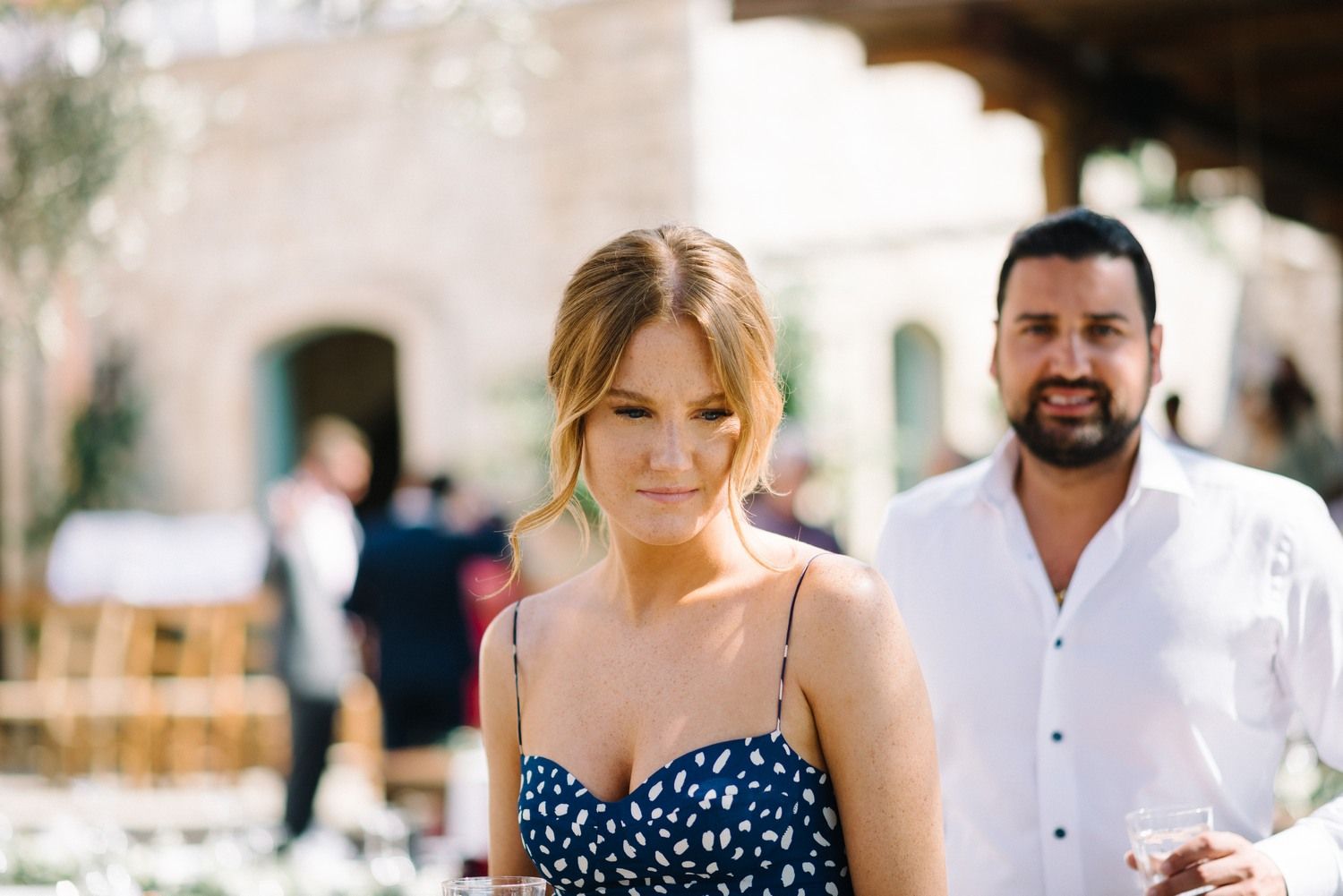 Guests enjoying a sunny outdoor wedding celebration at an elegant Mediterranean venue.
