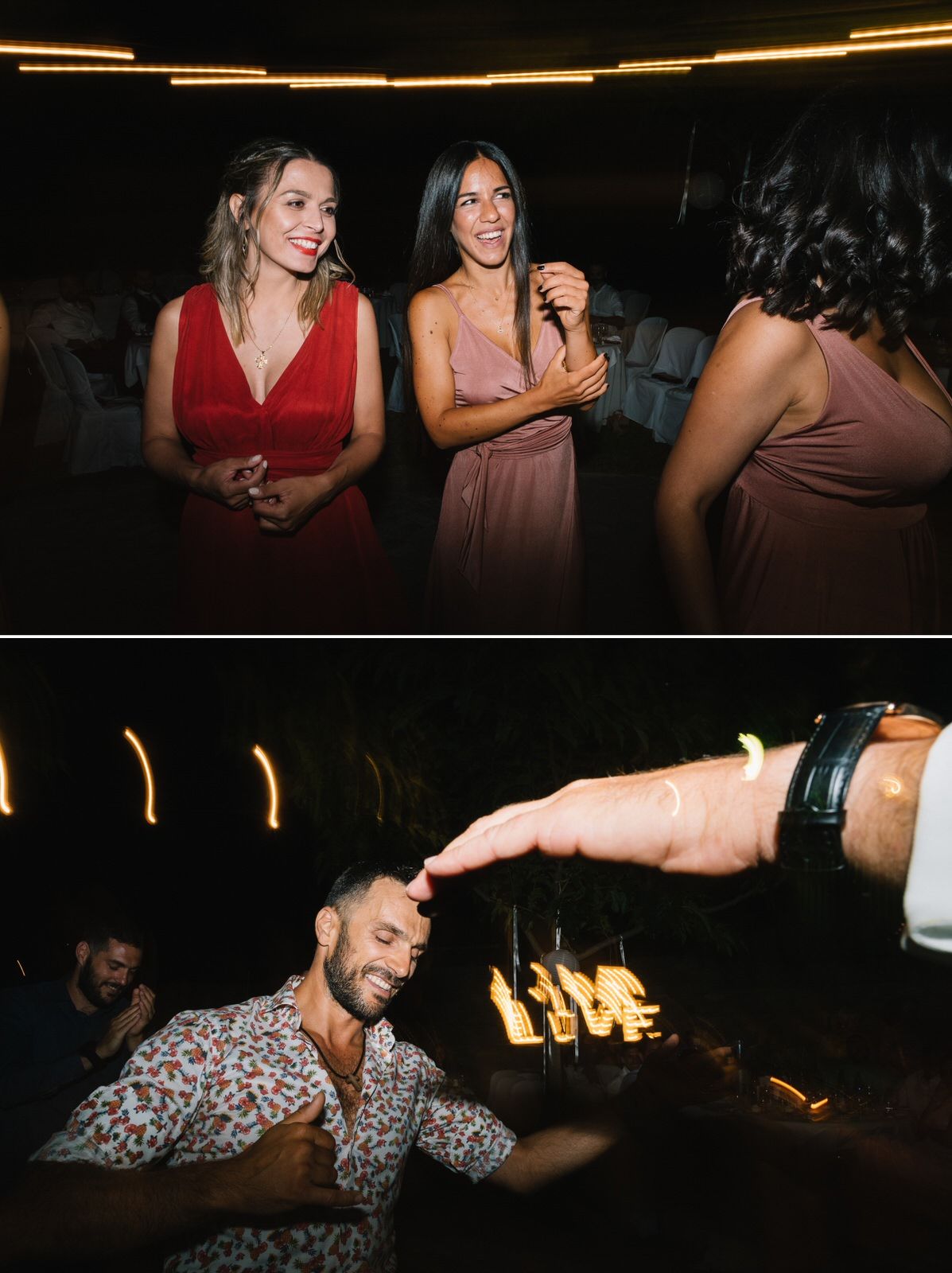 Wedding reception guests dancing and celebrating in a dimly lit venue.