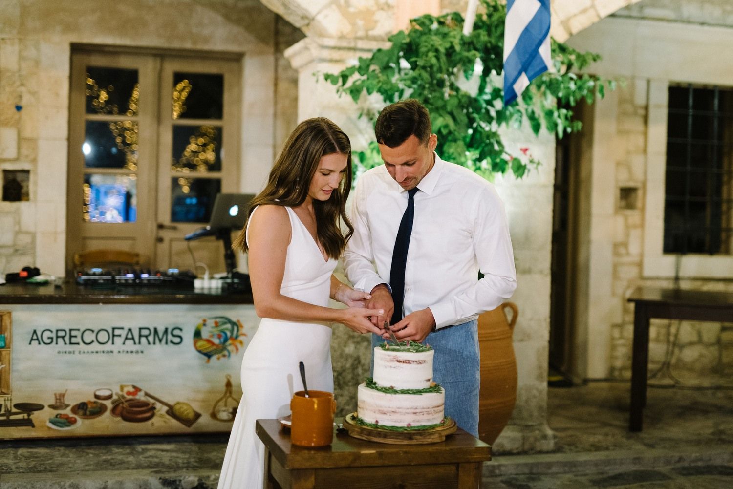 couple cutting wedding cake at agreco farms in crete