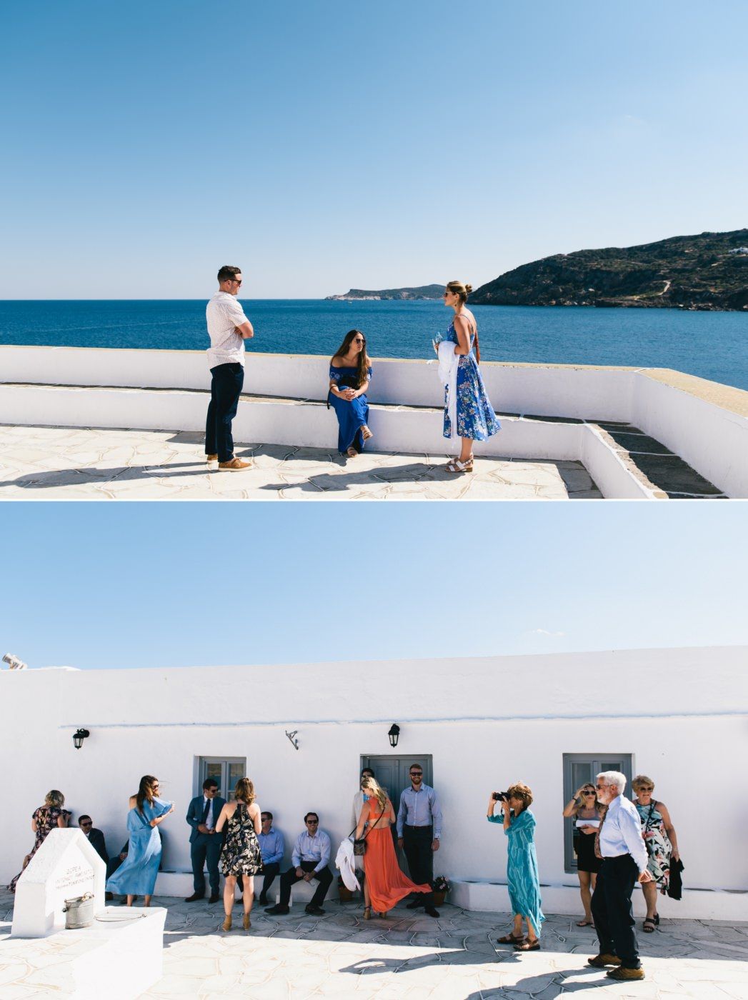 Wedding guests gathered on white Mediterranean terrace overlooking blue ocean.