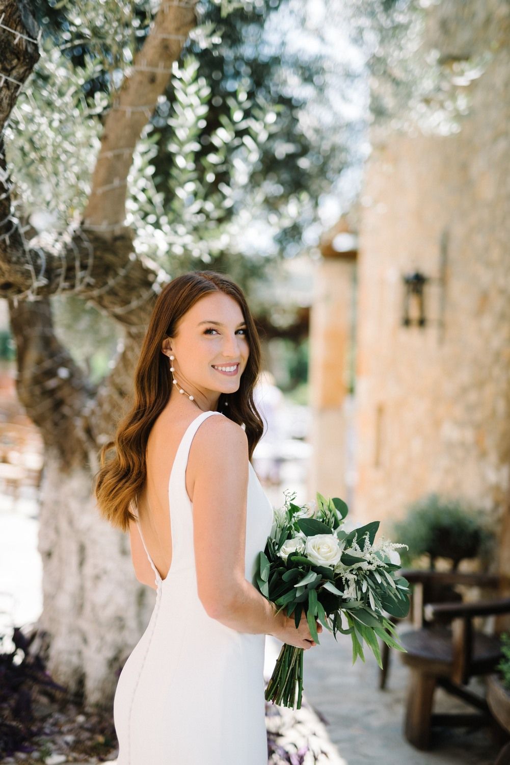 bride portrait holding the wedding flowers at agreco farms in crete greece