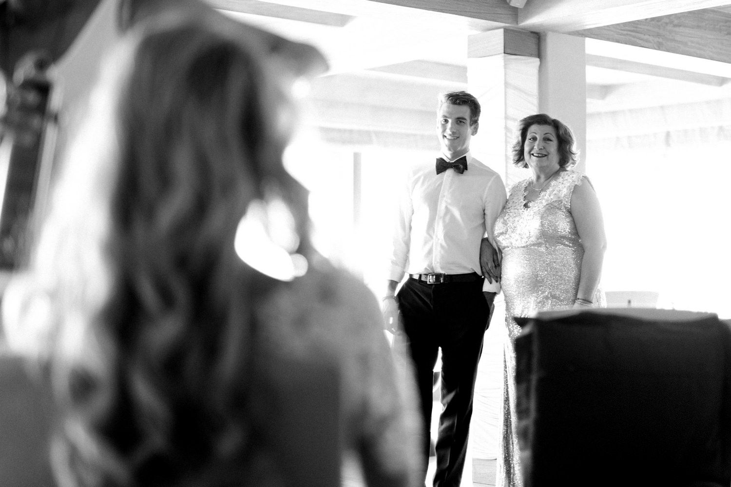Black and white candid moment during wedding preparations.