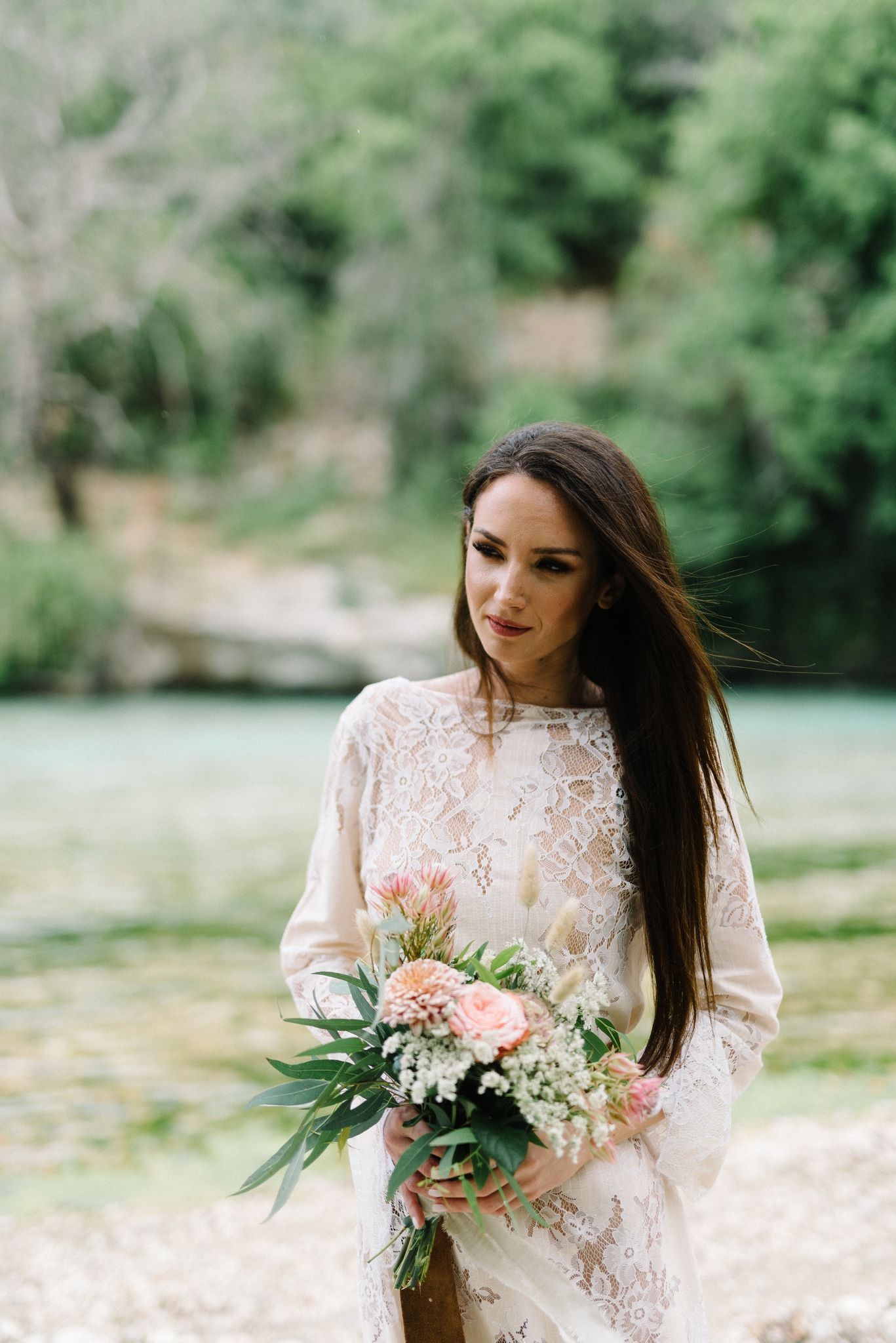 bride wearing nidodileda dress in acheron river