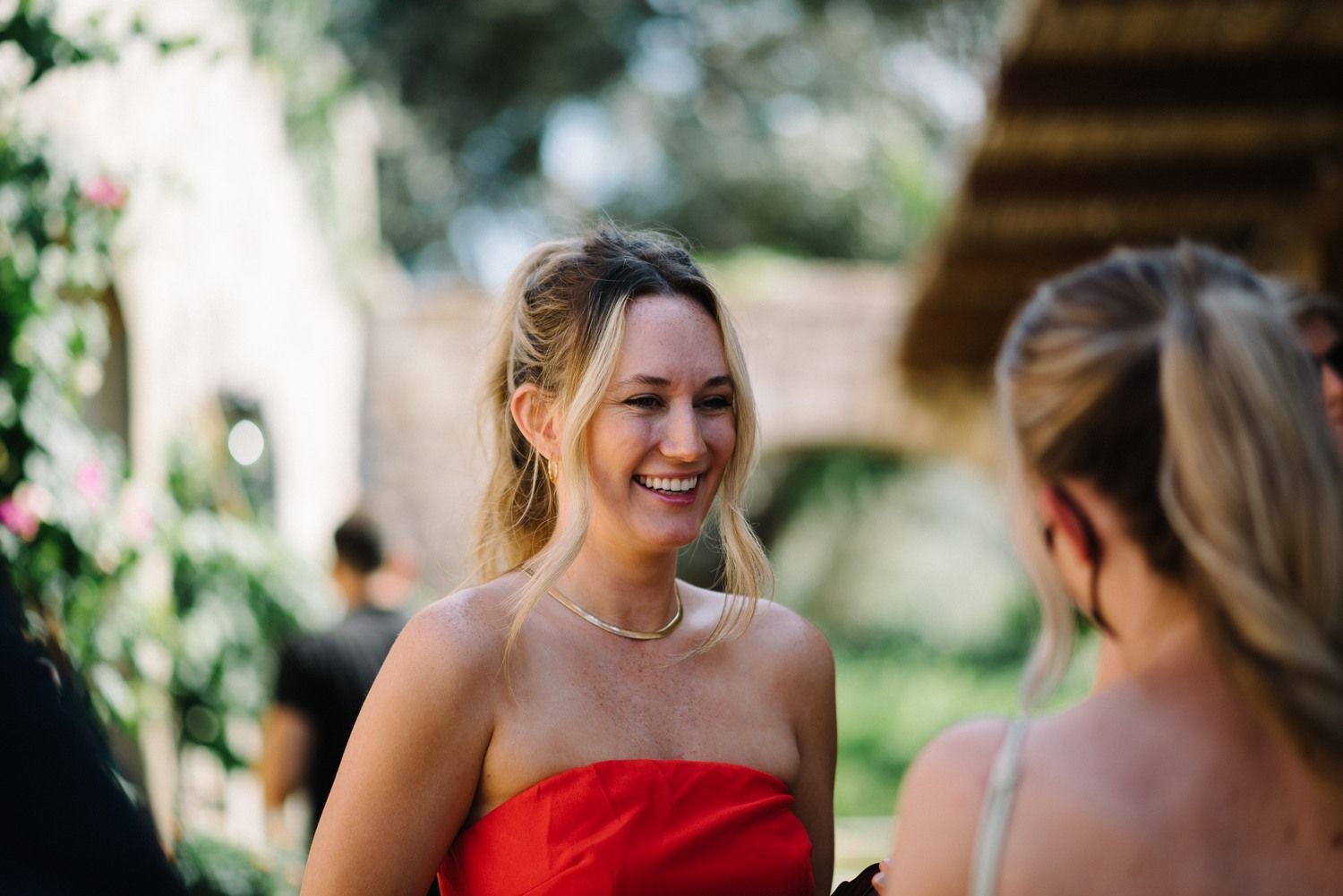 Wedding guests sharing a joyful moment during an outdoor celebration.