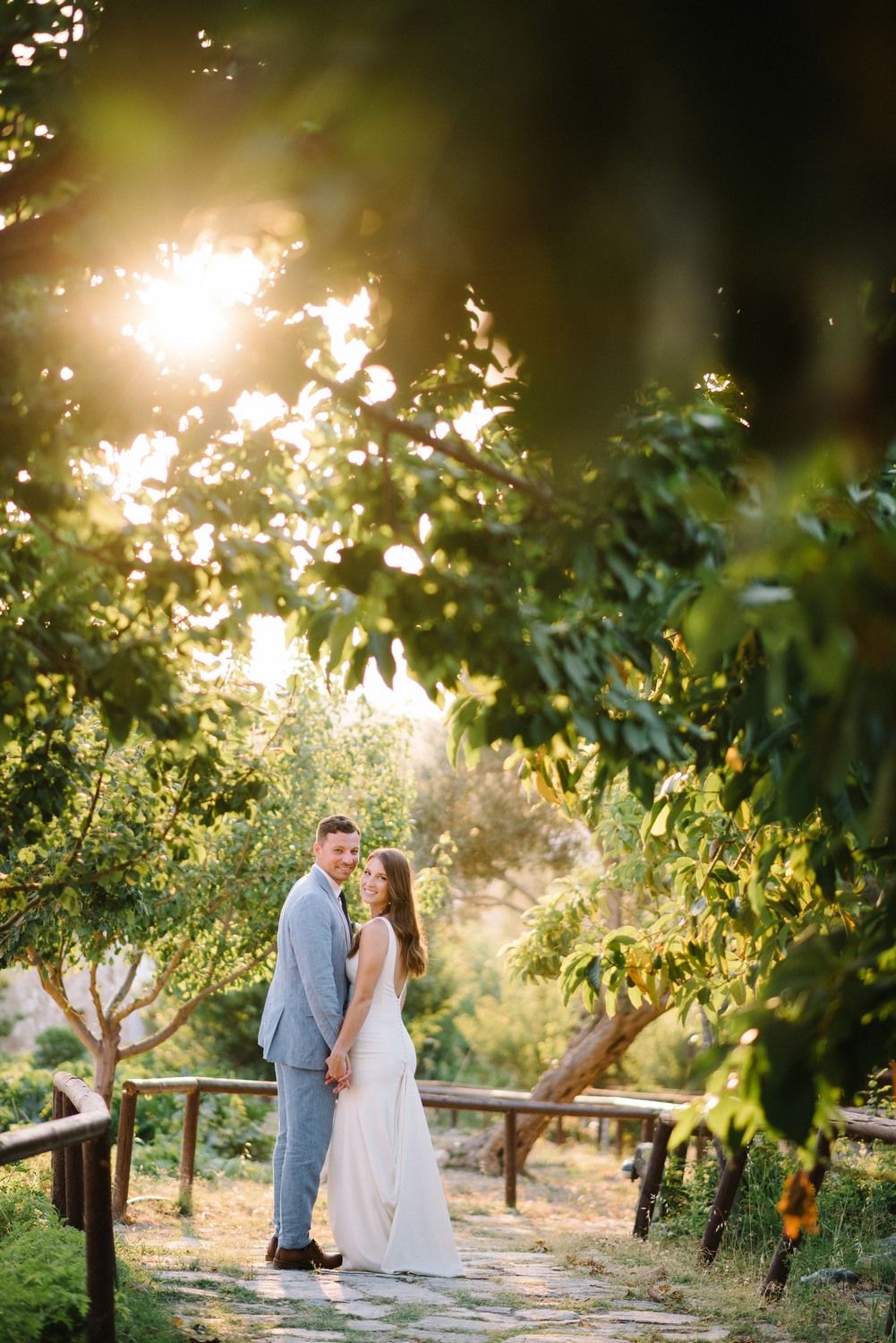 couple portraits under the sunset at agreco farms in crete greece