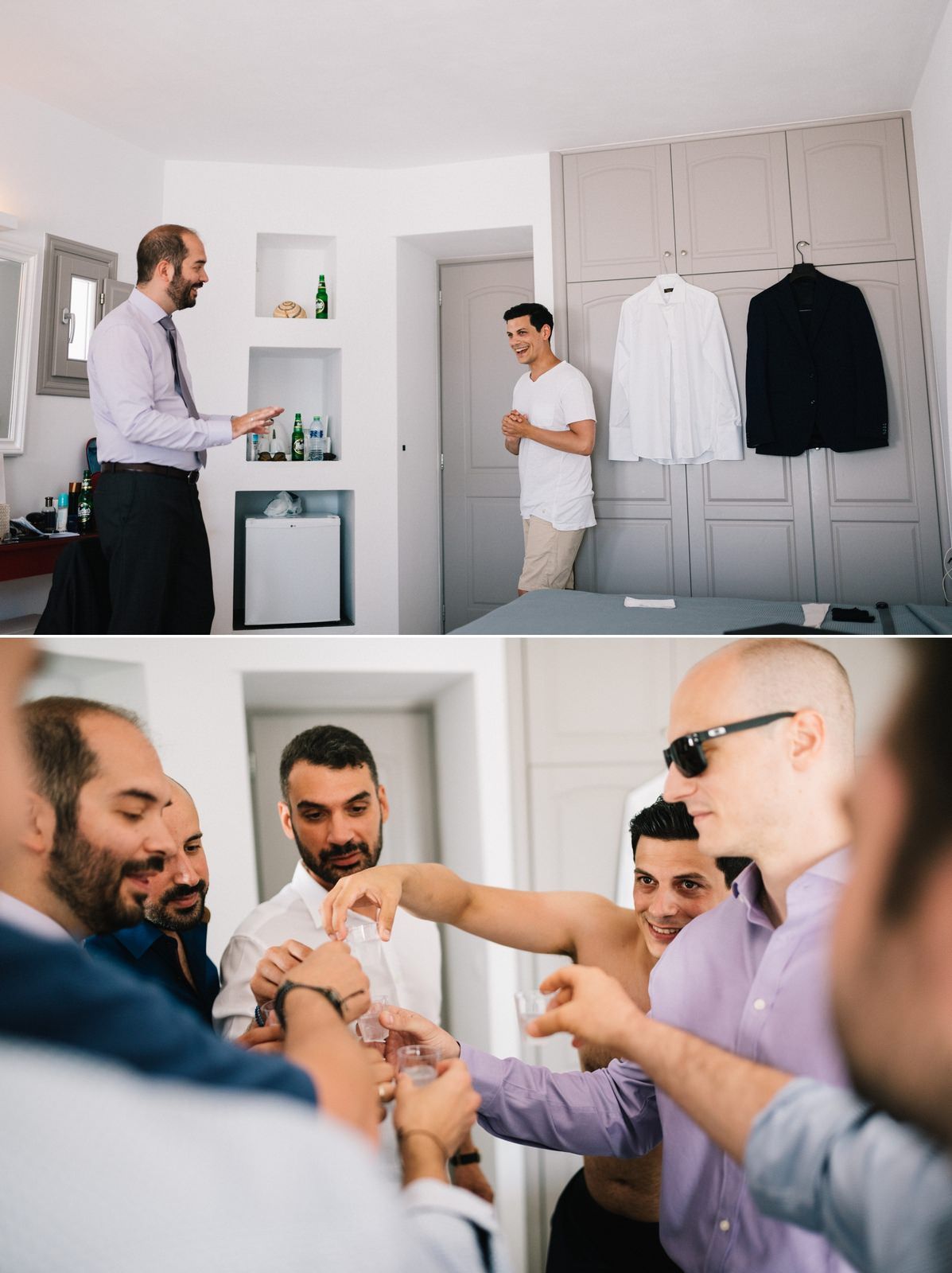 A bright room with white walls and built-in closets showing hanging formal attire.