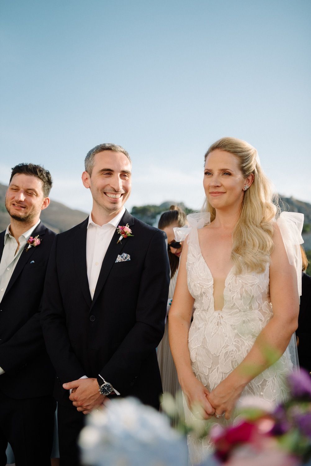 Wedding couple sharing a moment during their ceremony with mountain backdrop.