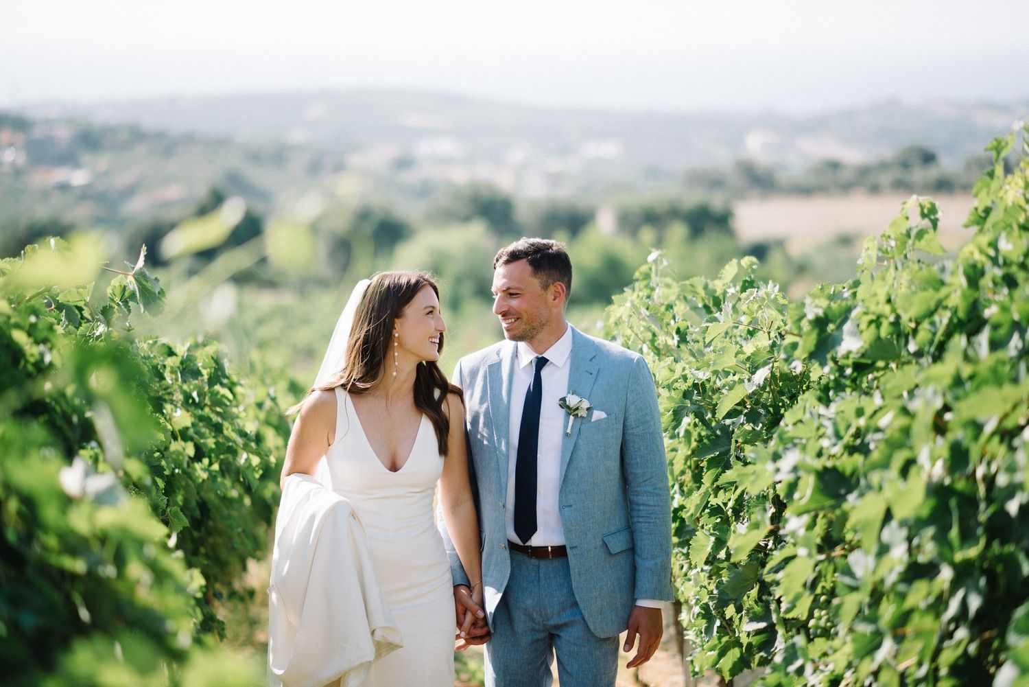 couple walking inside a vineyard at agreco farms in crete greece