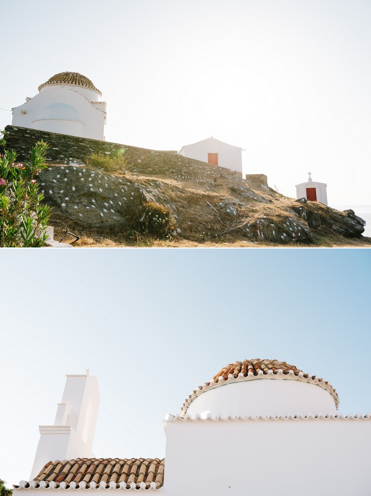 White Mediterranean architecture with domed buildings perched on a rocky coastal hillside.
