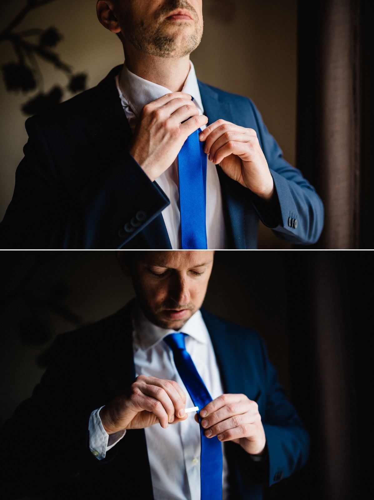 Close-up of formal attire showing a navy suit and bright blue tie adjustment.