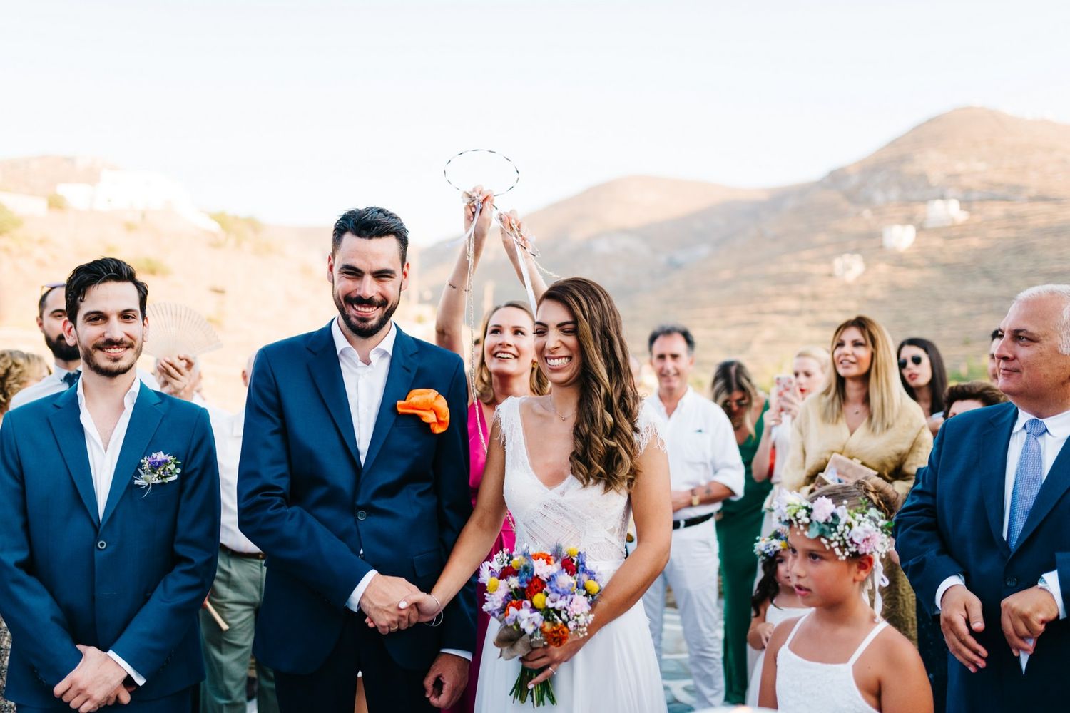 Wedding celebration on Mediterranean terrace with mountain views and festive atmosphere.