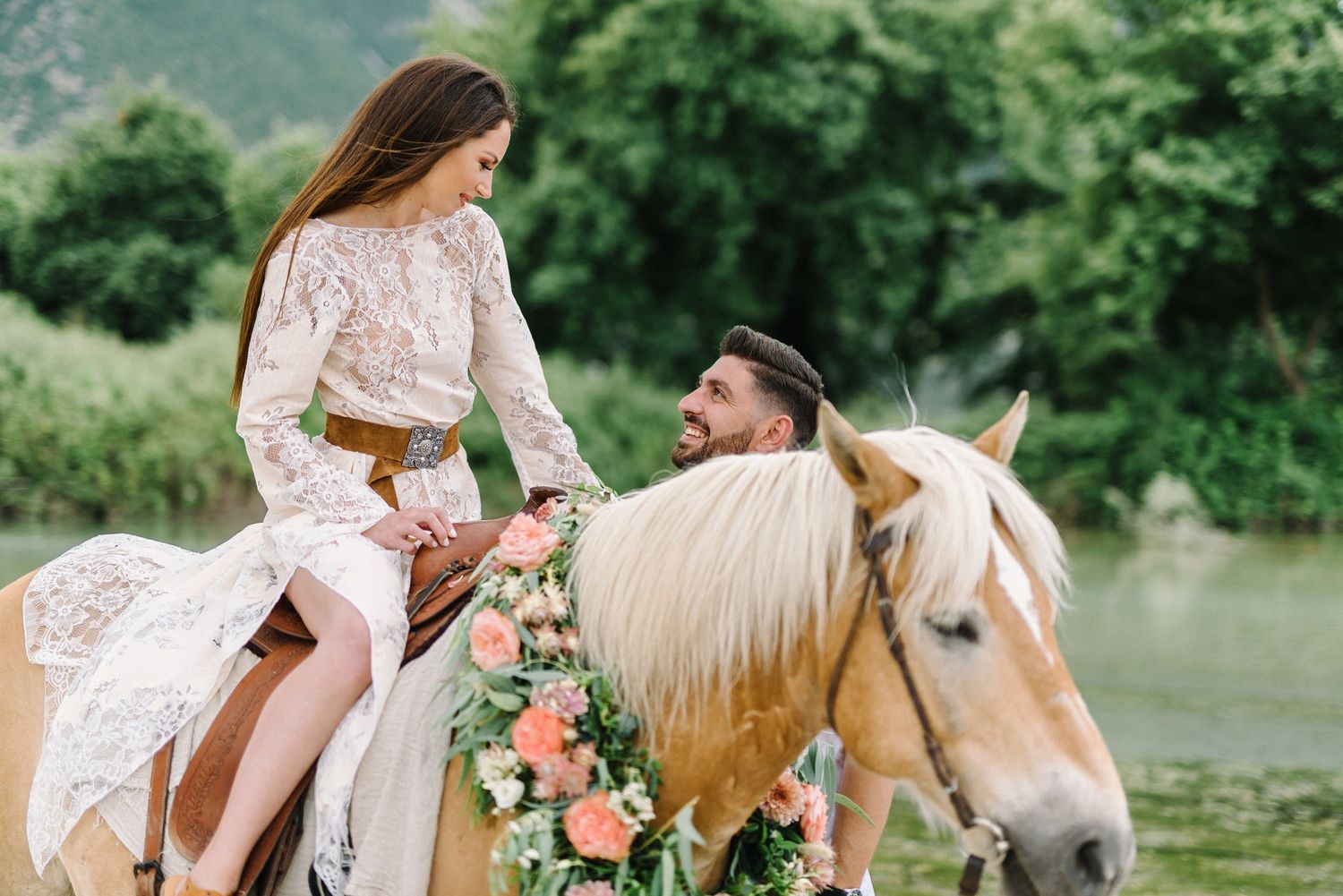 portrait of bride and groom riding a horse in acheron river in greece