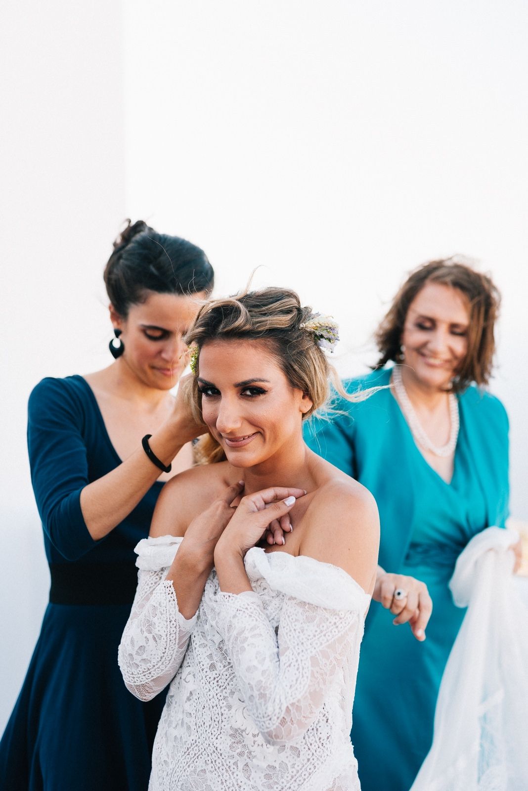bride wears an amazing wedding dress from Grace Loves Laces in folegandros