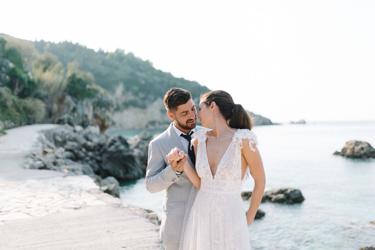 Intimate beachside moment with rocky coastline and ocean view.