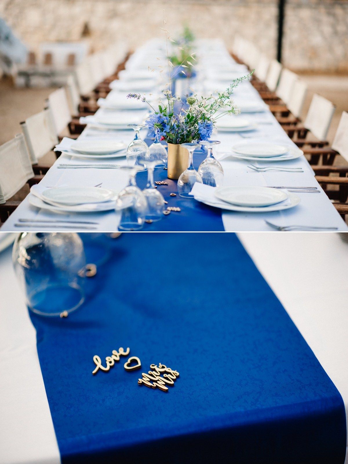 Elegant wedding table setting with blue runner and white place settings decorated with delicate blue flowers.