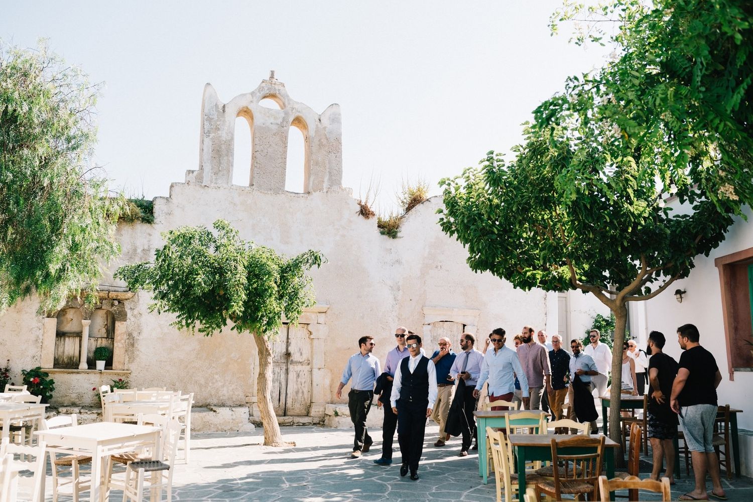 groom and his friends walking in the traditional alleys in folegandros