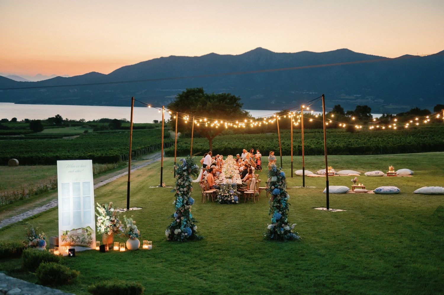 Panoramic view of an outdoor wedding ceremony setup at sunset at Kamkoutis vineyard, Velventos greece.