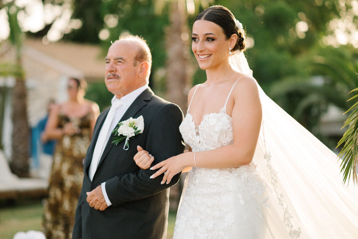 Traditional wedding processional moment captured in an outdoor garden setting.