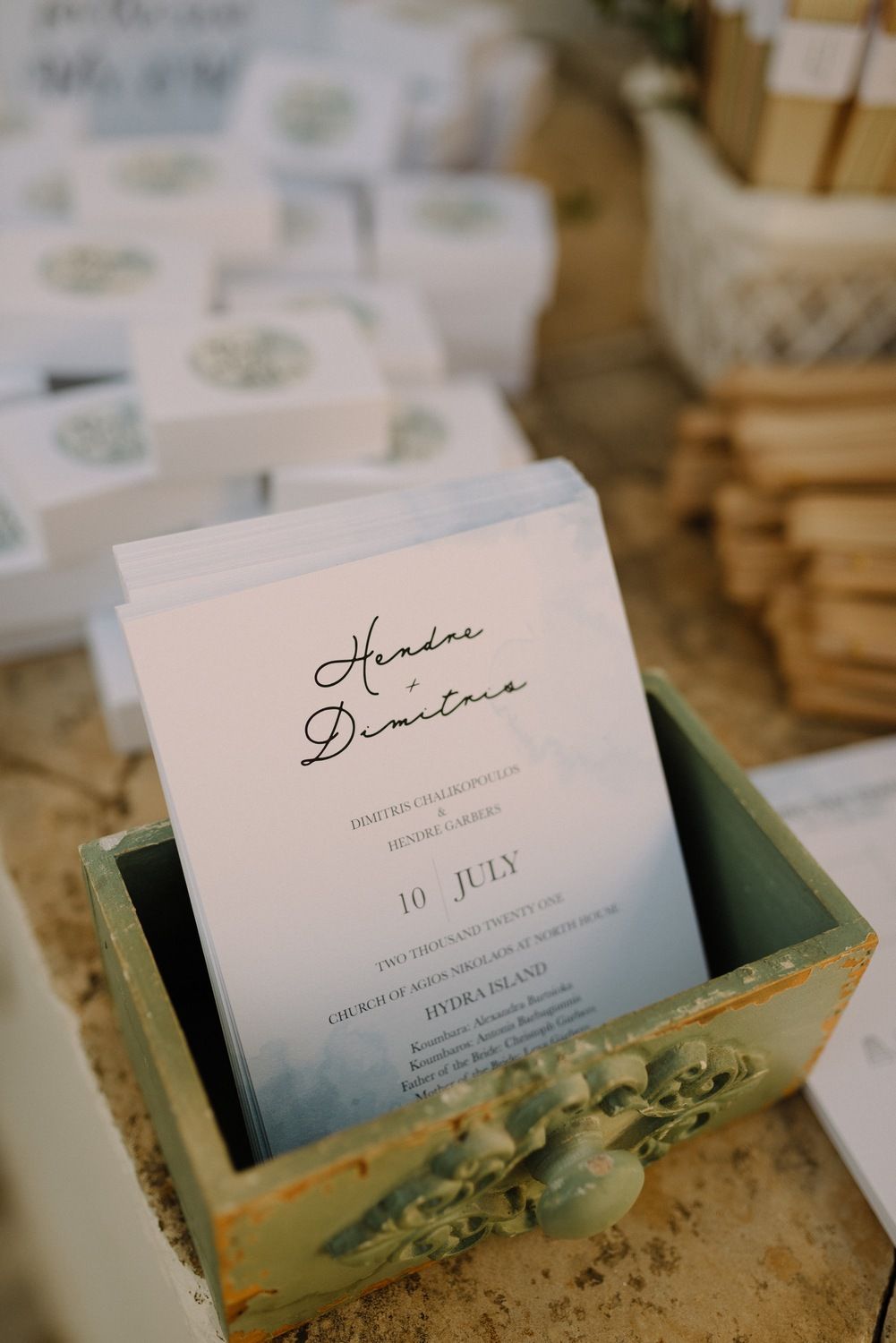 Elegant wedding invitation with July date displayed in vintage green box.