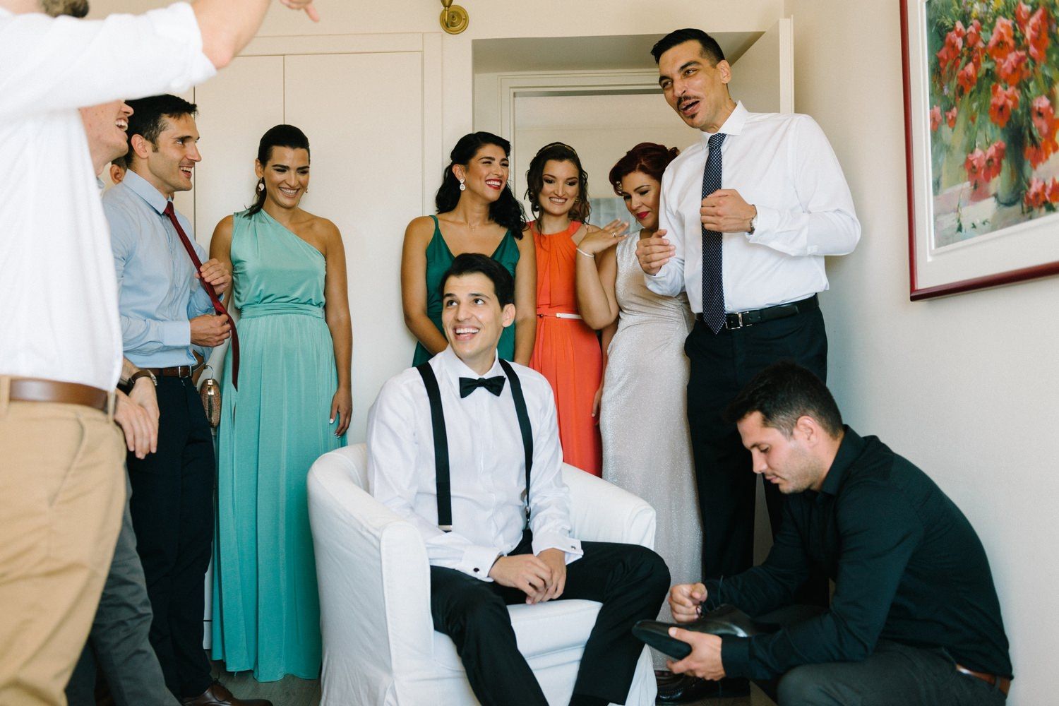 Wedding party gathered together in casual moment before ceremony.