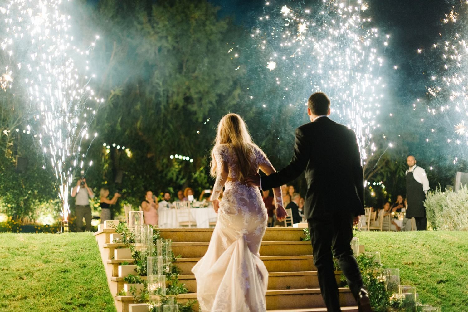 couple is entering with fireworks the wedding reception in athens riviera