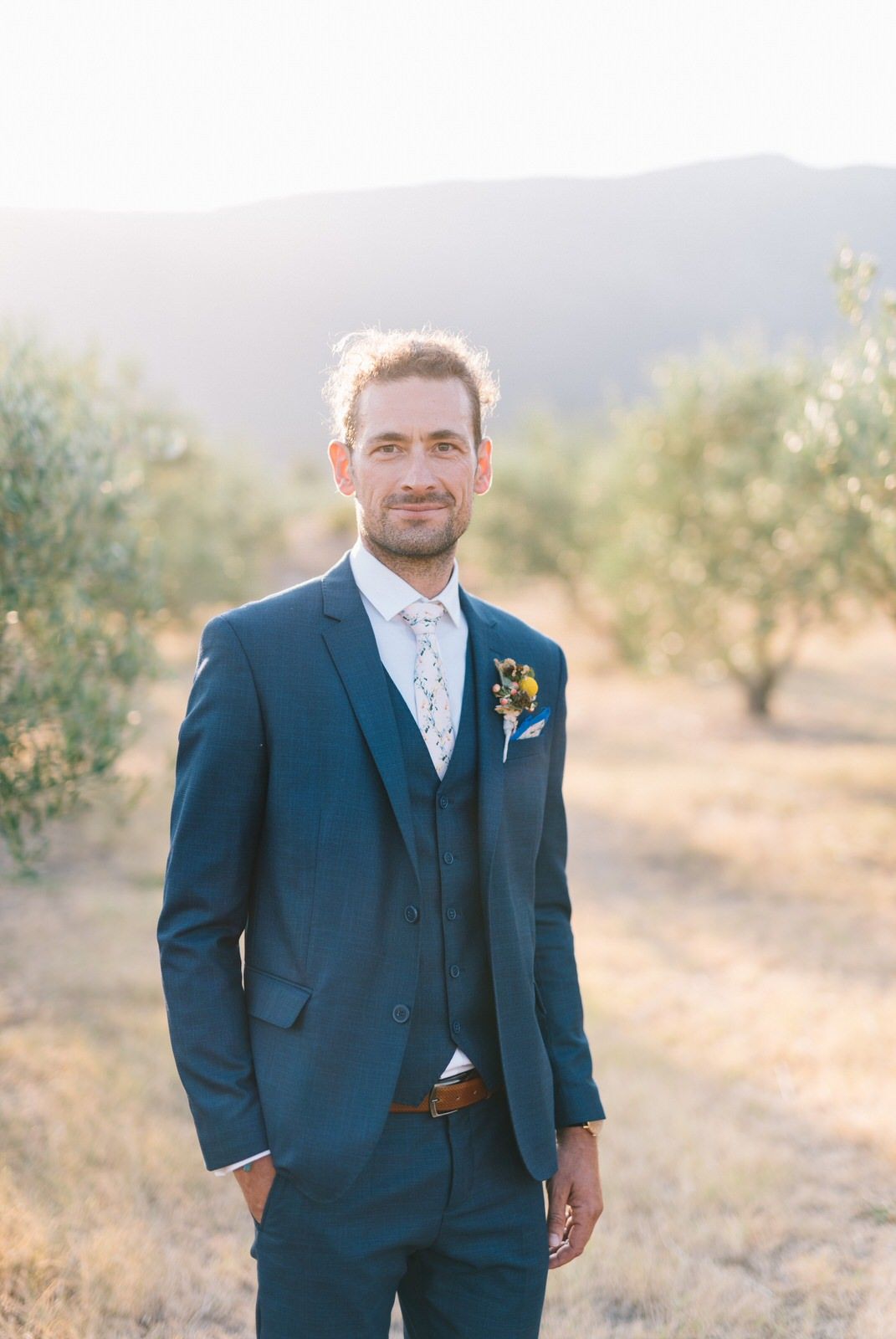 groom portrait in an olive field