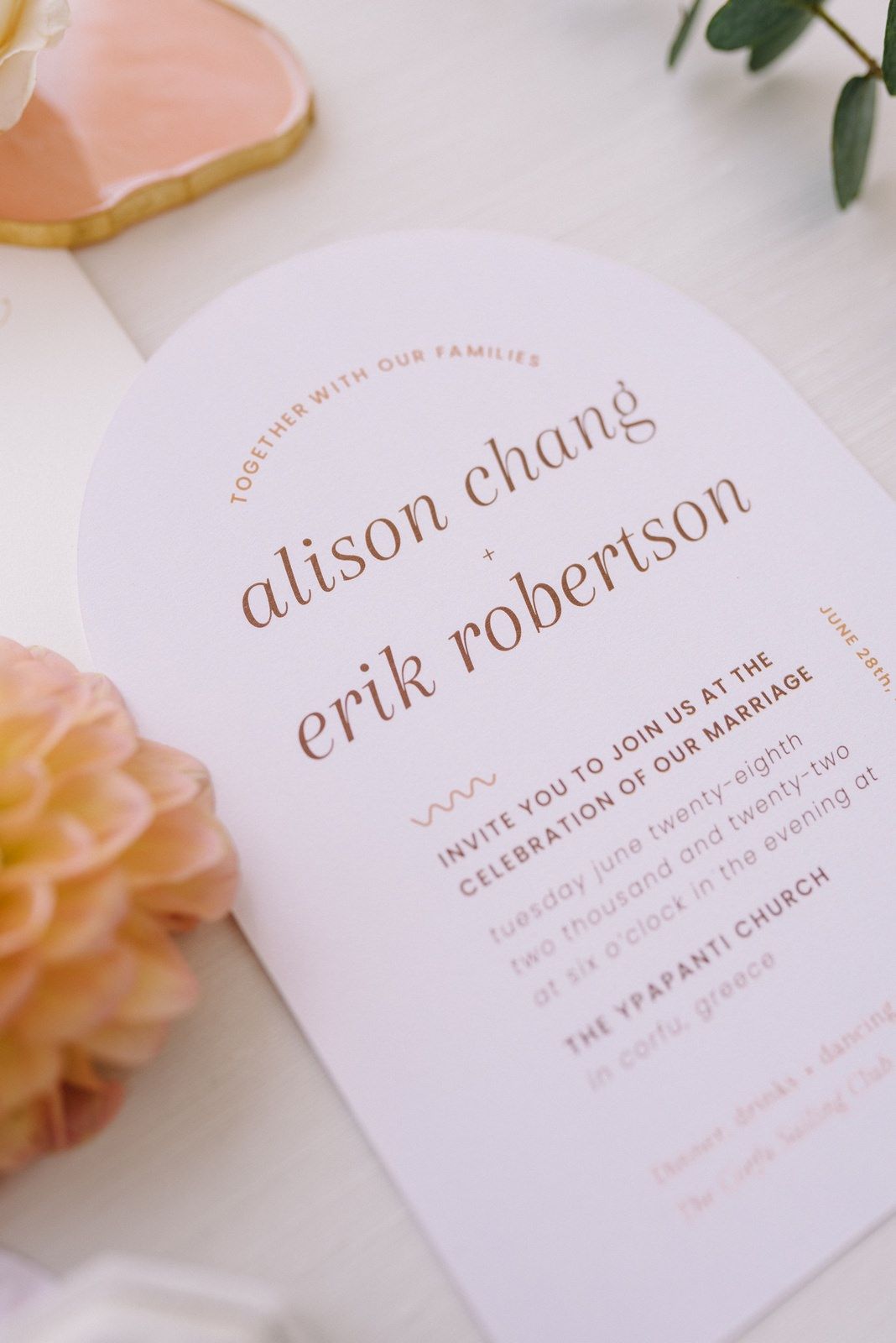 Elegant wedding invitation with names Alison Chang and Erik Robertson in soft rose gold text.