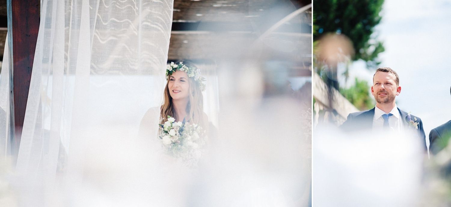 Dreamy wedding ceremony moment captured through sheer white curtains outdoors.