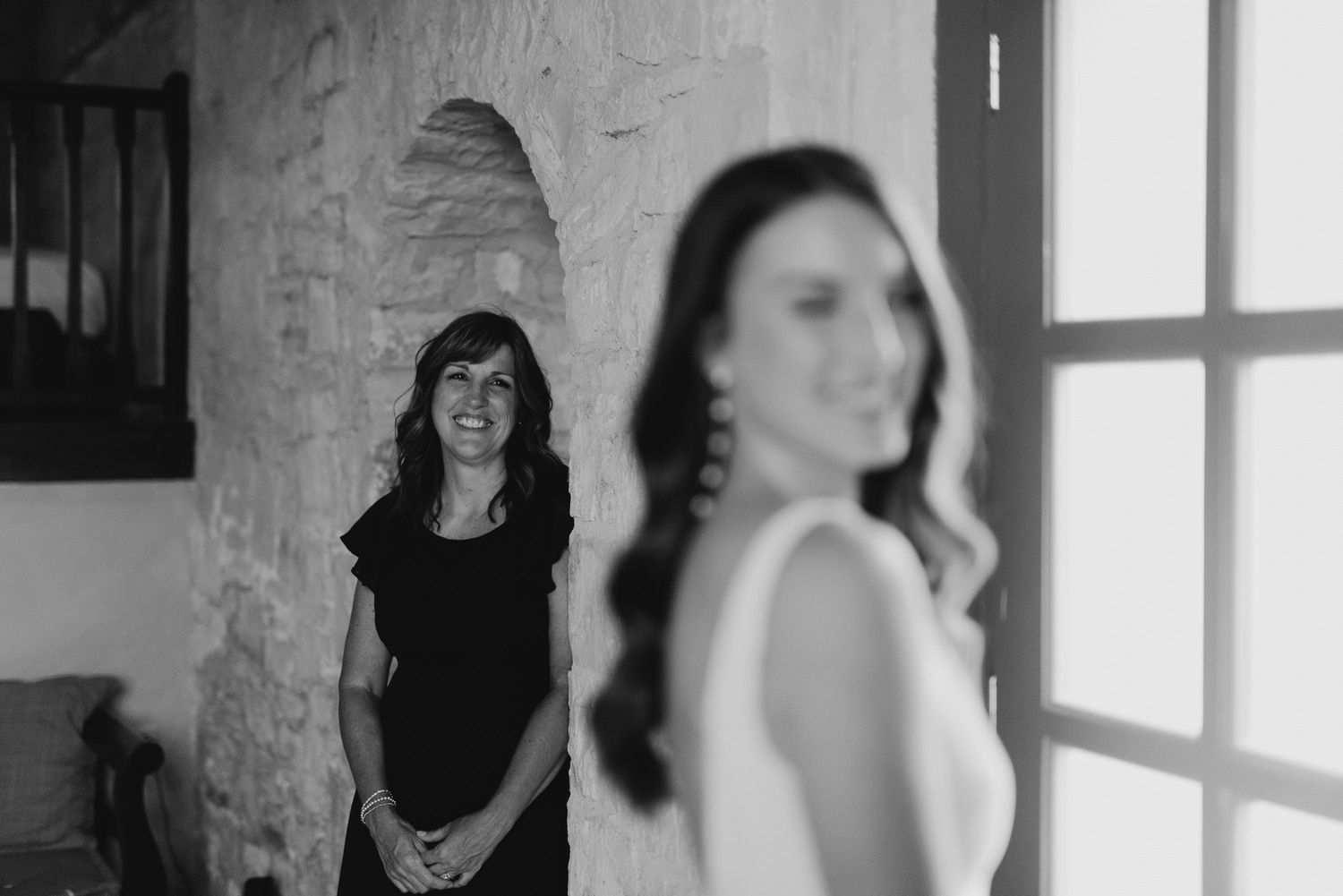 Black and white photo showing two women in an interior doorway.