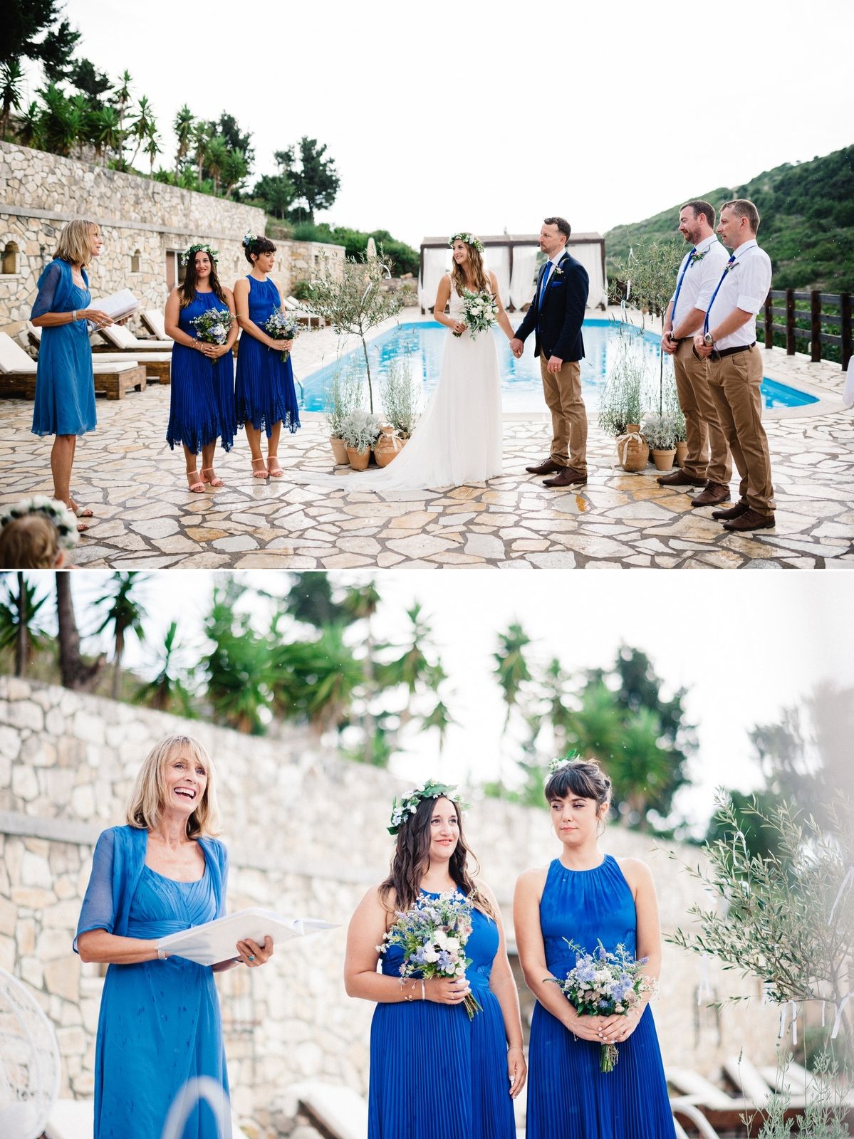 Wedding party in blue and neutral tones gathered for outdoor ceremony by pool with stone wall backdrop.