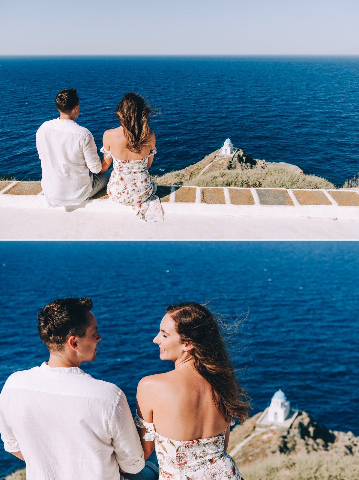 Couple sitting on white wall overlooking Mediterranean coastline and lighthouse on rocky peninsula.