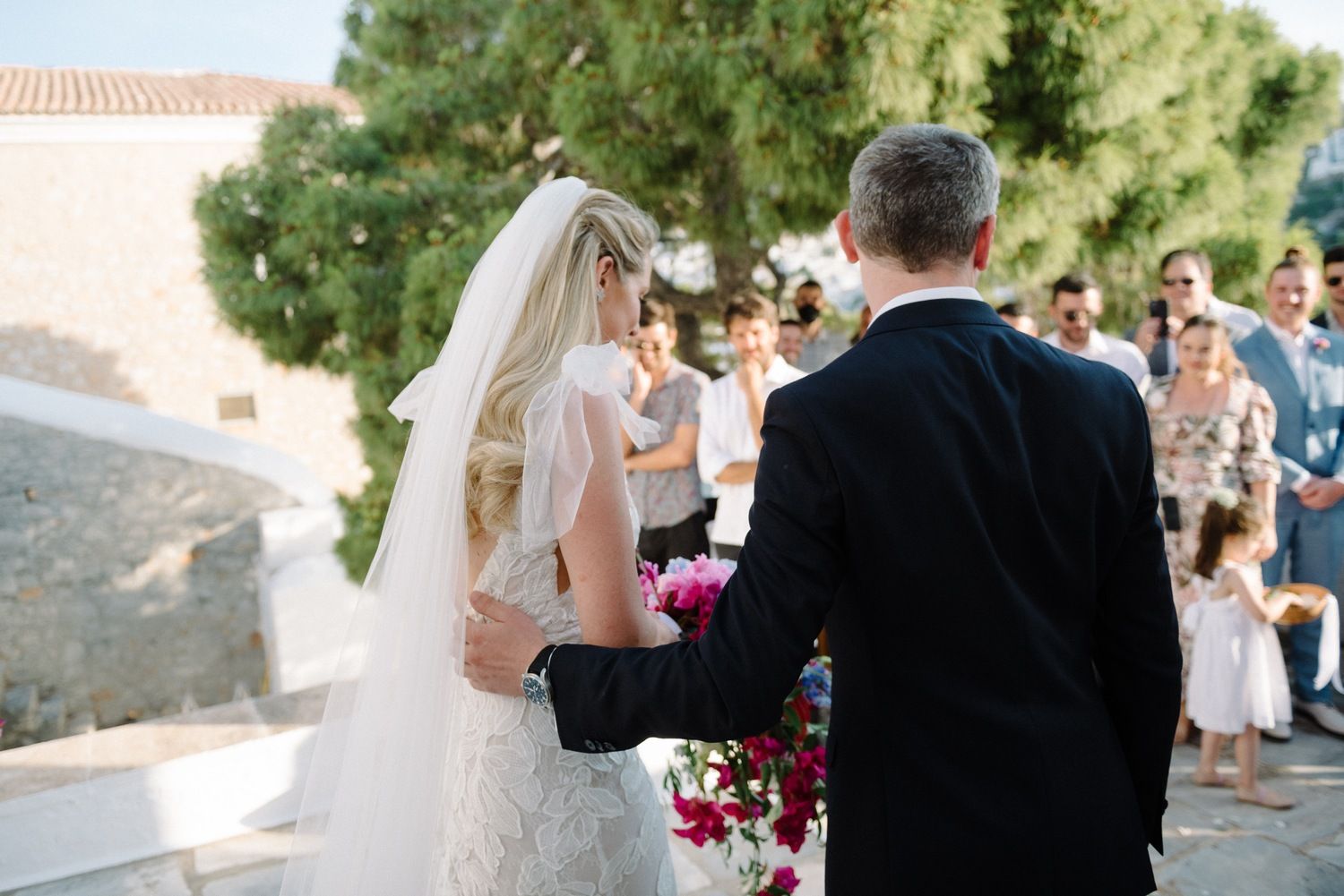 Outdoor wedding ceremony moment on scenic Mediterranean terrace overlooking mountains.