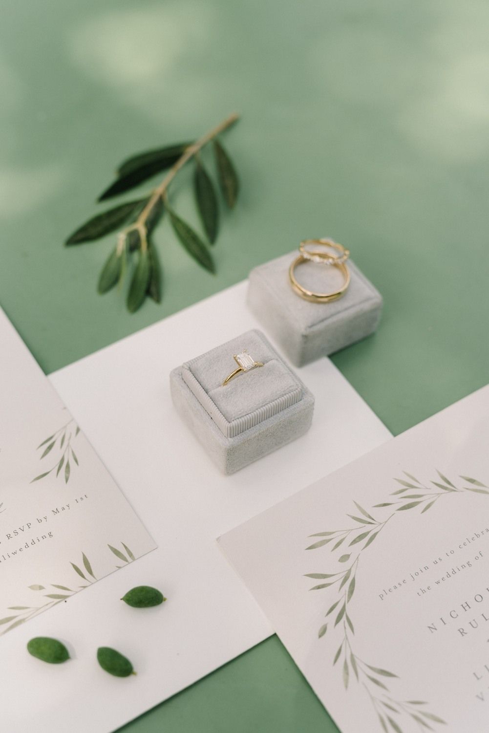 wedding stationery and engagement ring with olive green background details